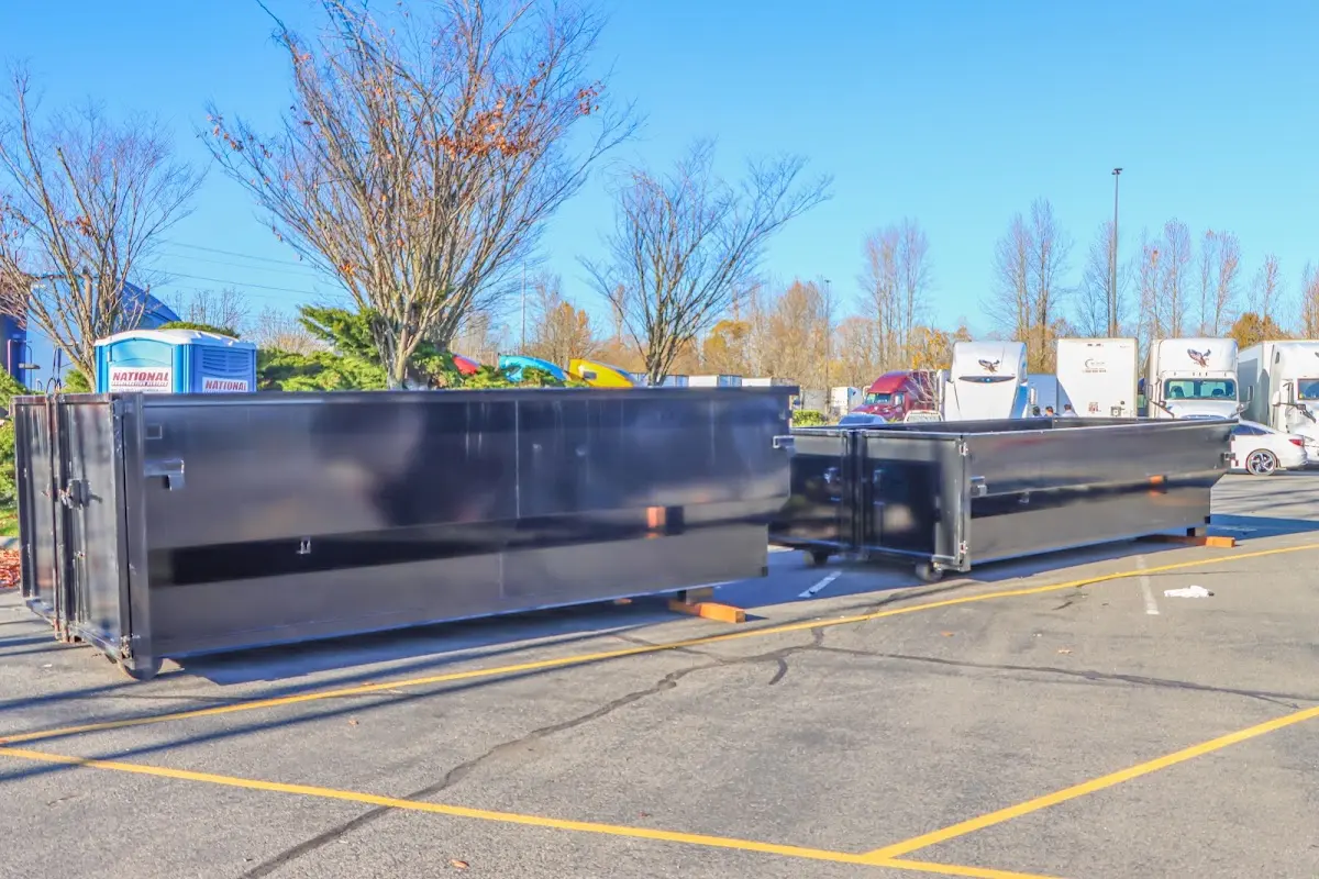 Professional dumpster rental service with roll-off container on residential driveway in Hartsville